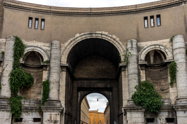 Arch of Titus in the Roman Forum, Rome, Italy, showing detailed carvings and relief sculptures inside the triumphal arch with blue sky framed beneath.