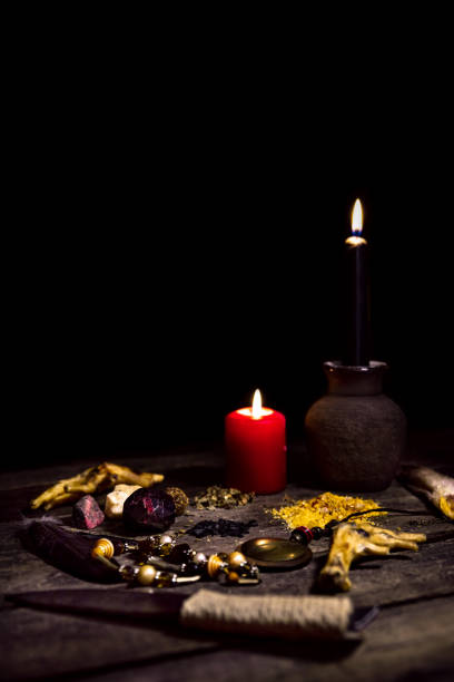 Dark vodun or voodoo ritual table in front of black background, magic and mystical african religion, copyspace