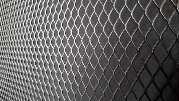 istock Metal mesh seamless pattern. Black metal mesh texture on a black background. Bulletin board for text and message design. Rhombus shape 1270037923