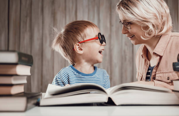 istock Five years old child reading a book at home with mother 1270038231