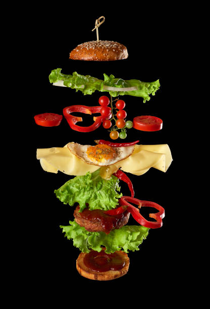 istock flying cheeseburger ingredients: meat cutlet, sesame loaf, cheese, fried egg, tomato and green lettuce 1270038582