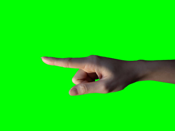 istock isolated hand with finger pointing  on bright object. die cut on green background. 1270039946