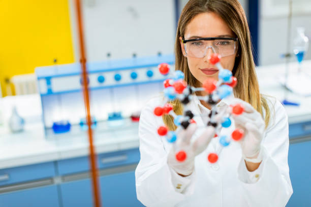 istock Female chemist hold molecular model in the lab 1270040077
