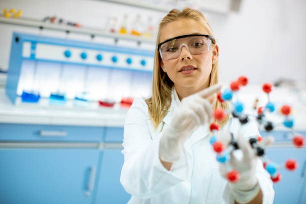 istock Female chemist hold molecular model in the lab 1270040162