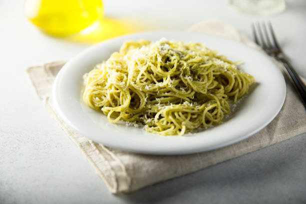 Spaghetti with pesto sauce and cheese