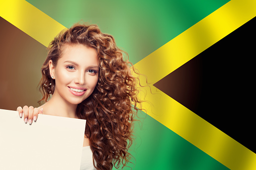 Travel and study in Jamaica concept with Pretty girl student with white banner against Jamaica flag background