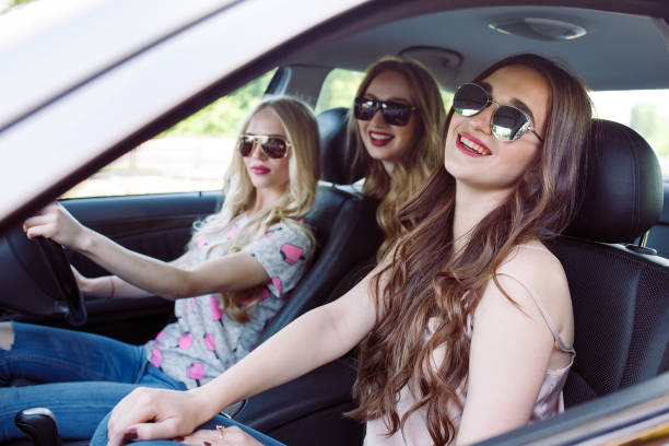 istock Three young girlfriends traveling in a car. 1270043707