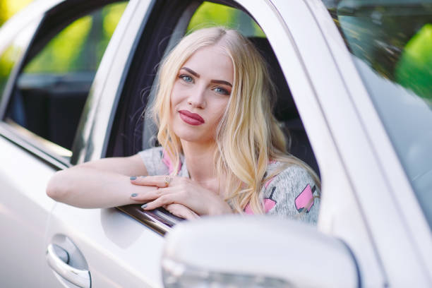 istock A young beutiful girl is driving a car. 1270043751