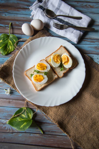 istock Vertical view of boiled eggs on slices of bread 1270043814