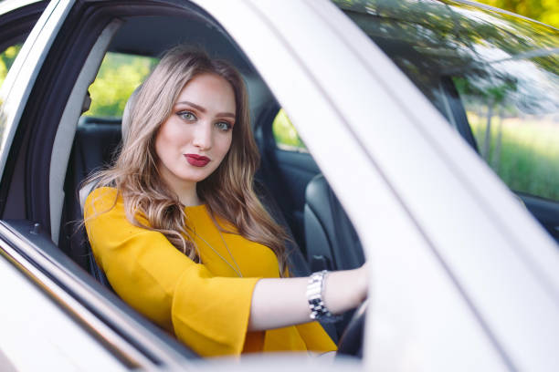 istock A young beutiful girl is driving a car. 1270043875