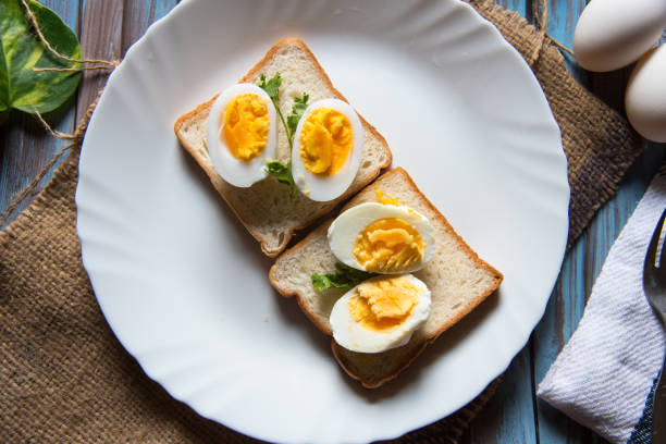 istock Close  up of boiled eggs on bread slice 1270043903