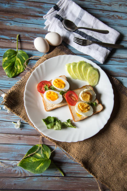 Boiled egg with bacon and vegetables in a plate on a background