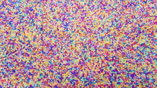 Lots of different colored hydrogel balls. Set of multicolored orbis. Crystal water beads for games. Helium balloons. Can be used as a background. Polymer gel Silica gel