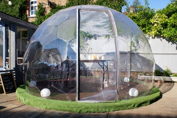 Plastic igloo dome tent used to dine outside pub during the Coronavirus (Covid-19) pandemic Chorleywood, Hertfordshire, England, UK - September 1st 2020: Plastic igloo dome tent used to dine outside pub during the Coronavirus (Covid-19) pandemic dome tent photos stock pictures, royalty-free photos & images