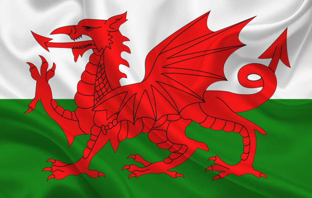 istock Wales country flag on wavy silk fabric background panorama 1270047564
