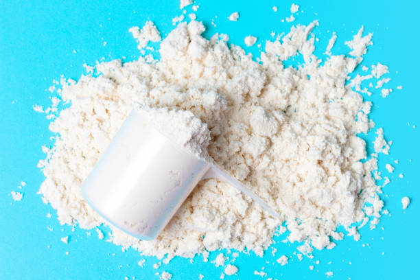 istock Scattered protein in scoop on blue background top view 1270047980