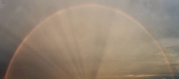 istock Rainbow in the sky with clouds and sun beams, natural background 1270048056