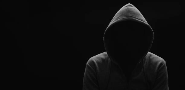 istock dark mysterious man in a hoodie is hiding his face, hacker, anonymous 1270048233