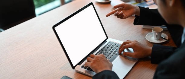istock A businessman is using a computer laptop with a white blank screen at the meeting table. 1270052363