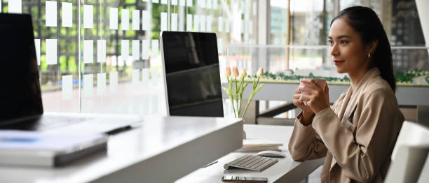 istock A businesswoman is holding a coffee cup while sitting in the modern office. 1270052643
