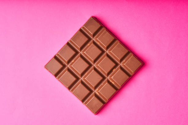istock Bar of milk chocolate on a colored paper background 1270053569