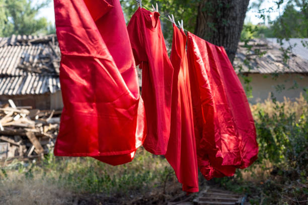 istock red silk bedding, sheets, rope dry, hanging outside 1270053622