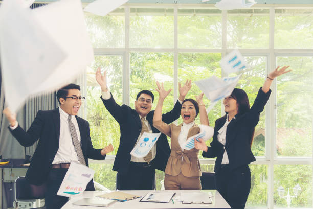 istock Teamwork Success. Celebrating Asia group business people group team throwing document 1270056985