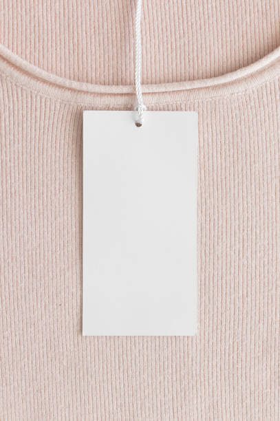 istock White clothing tag mockup on a soft pink sweater. 1270058449