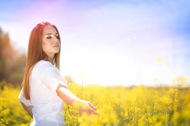 istock Peaceful woman touching flowers in meadow 1270059302