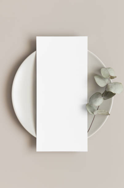 istock Menu card mockup with a eucalyptus branch on a plate, 4x9 ratio. 1270059329
