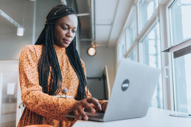 istock young black woman working at laptop at desk 1270060855