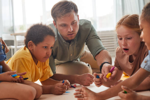 istock Children Drawing on Floor in Preschool 1270060983