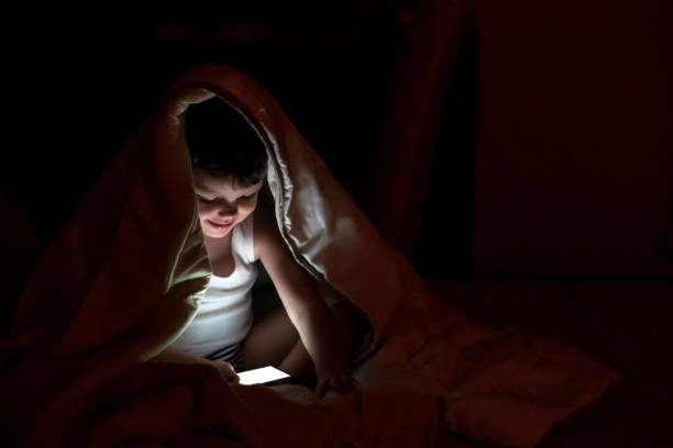 istock Caucasian kid playing games on smartphone. 1270063457