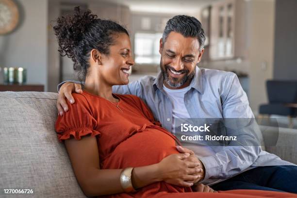 Happy Mixed Race Couple Expecting Baby Stock Photo - Download Image Now - Pregnant, Couple - Relationship, Women