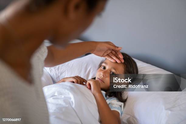 Worried Mother Checking Daughter Temperature Stock Photo - Download Image Now - Child, Illness, Fever