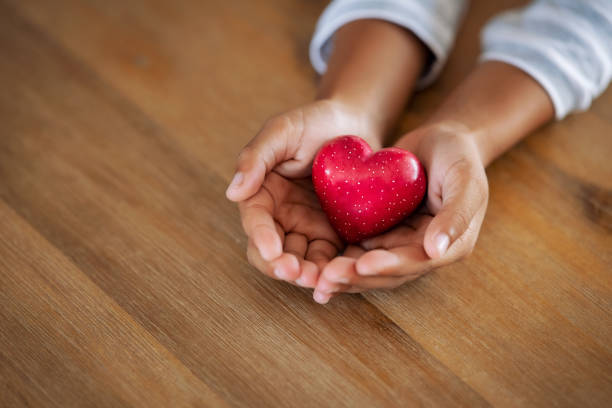 istock Little child holding red heart in her hands 1270067151