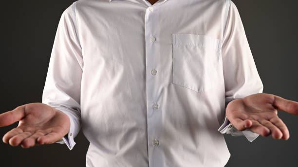 istock a man in a white shirt makes a helpless gesture 1270069051