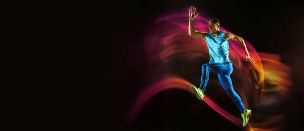 istock Professional male runner training isolated on black studio background in mixed light 1270070366