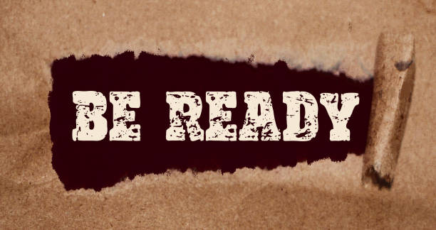 istock Be Ready words appearing behind torn brown paper. Business startup or virus prevention concept 1270070425