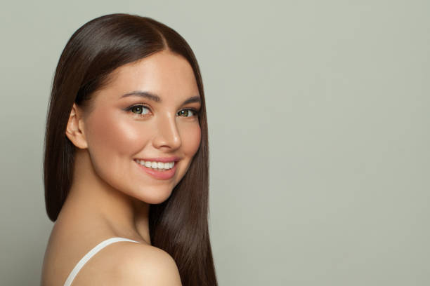 Pretty model woman with clear skin and long healthy straight hair. Skincare and facial treatment concept Pretty model woman with clear skin and long healthy straight hair. Skincare and facial treatment concept beauty stock pictures, royalty-free photos & images