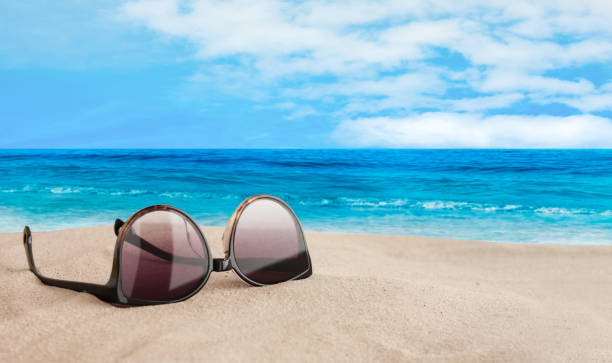 istock Sunglasses on the seashore,tropical beach vacation background 1270073932