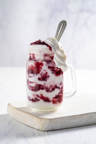 istock Raspberries yogurt smoothie overflow on a white board 1270075013
