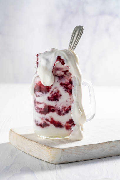 istock Raspberries yogurt smoothie overflow on a white board 1270075028