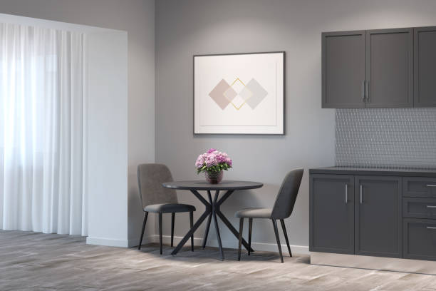 istock Kitchen interior with the horizontal poster above a round table with two chairs between gray kitchen cabinets and a doorway. 1270076622