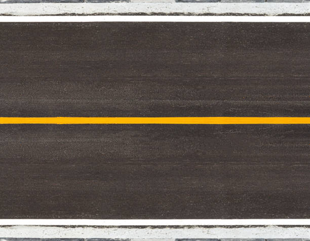 istock asphalt road with marking lines yellow stripes traffic on the road surface texture Background. 1270077529