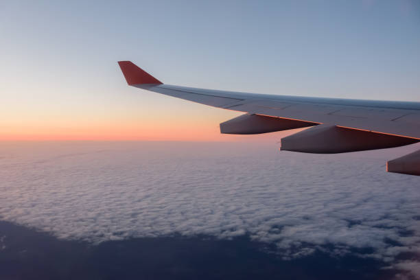 istock Wing of a airplane at sunrise. 1270077870