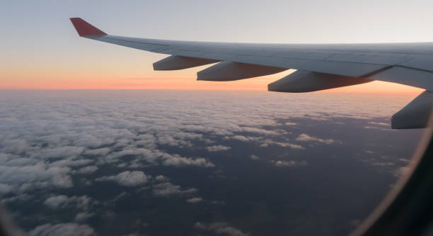istock Wing of a airplane at sunrise. 1270077902