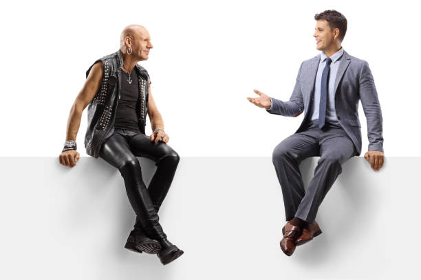 istock Punk talking with to a young man in a suit and tie while sitting on a panel 1270079545