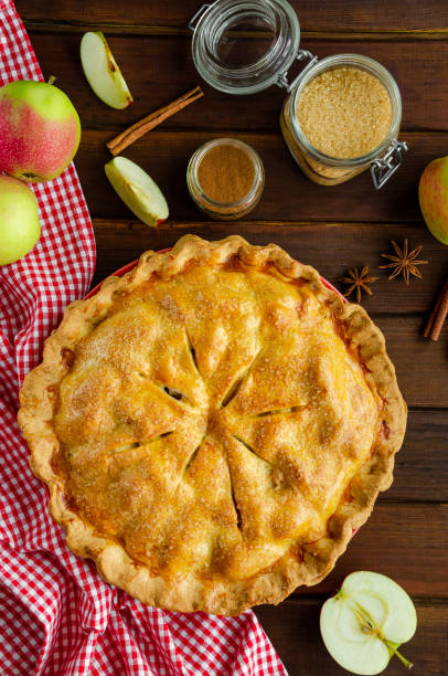 istock Classic American apple pie with cinnamon on a dark wooden background. Rustic style. Top view, copy space. 1270084059