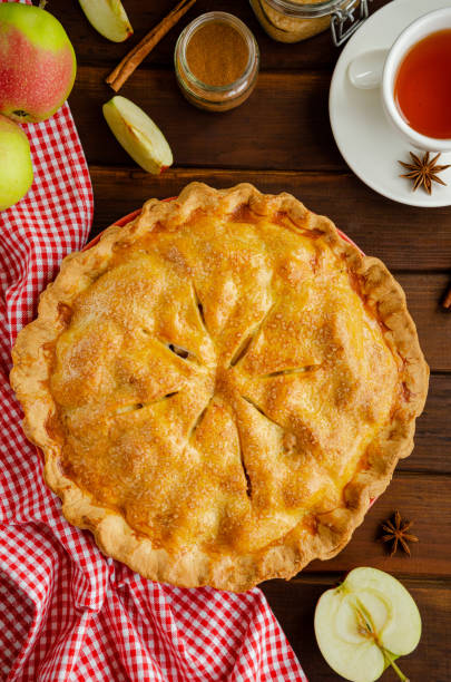 istock Classic American apple pie with cinnamon on a dark wooden background. Rustic style. Top view, copy space. 1270084072